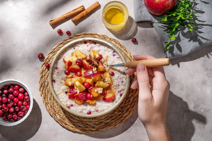 Oatmeal bowl with apple cranberry topping and honey – golden cinnamon oatmeal recipe with Ceylon cinnamon